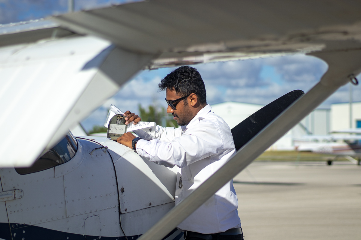 Pilot performing a preflight inspection on the aircraft