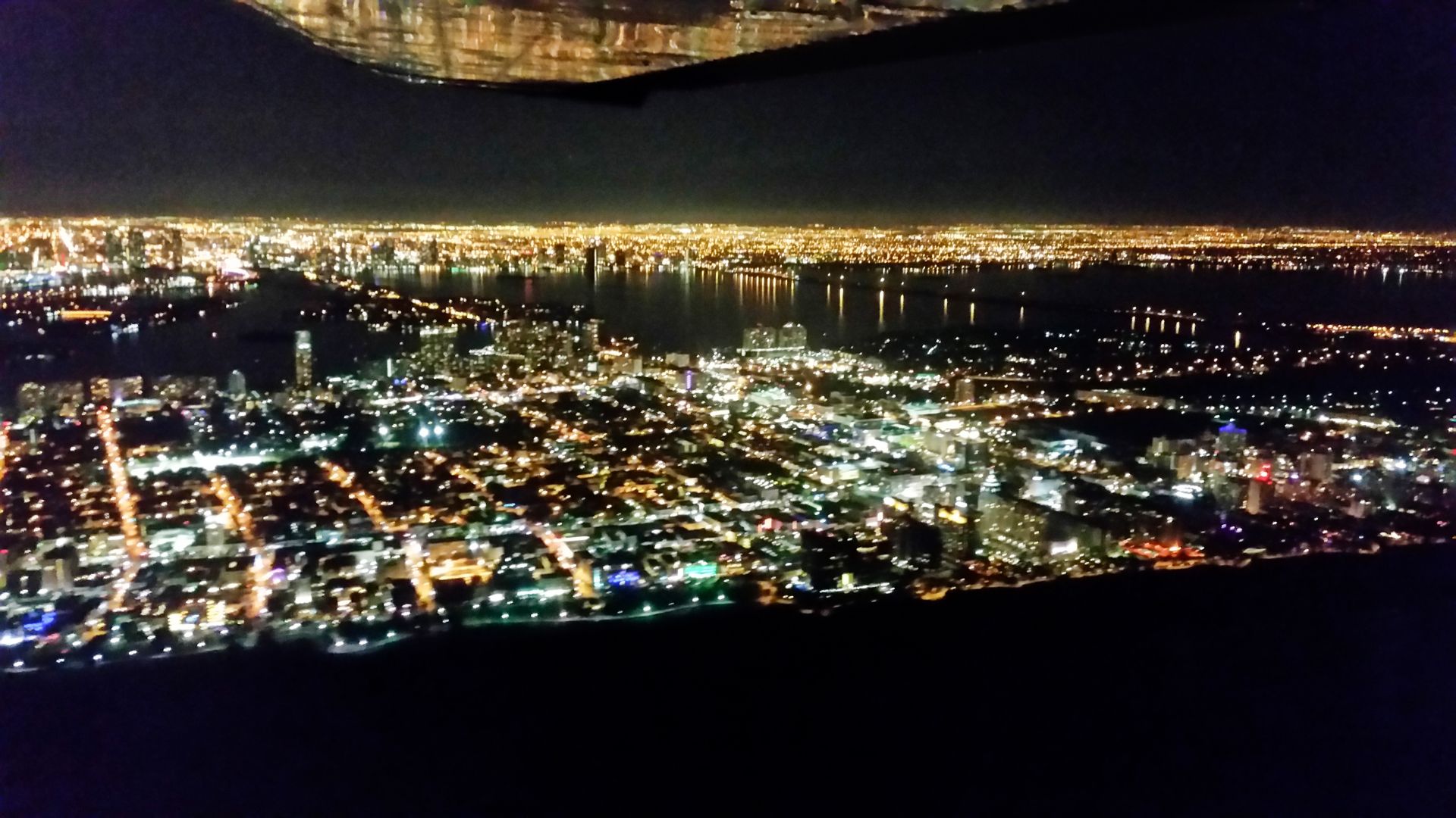 Night aerial view of the Miami skyline from the aircraft