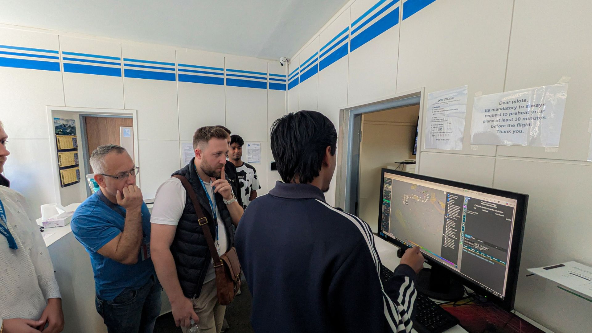 Open Doors Day visitors reviewing flight planning systems